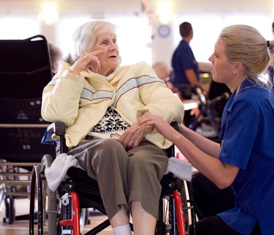 Decorative image - health staff talking to aging patient