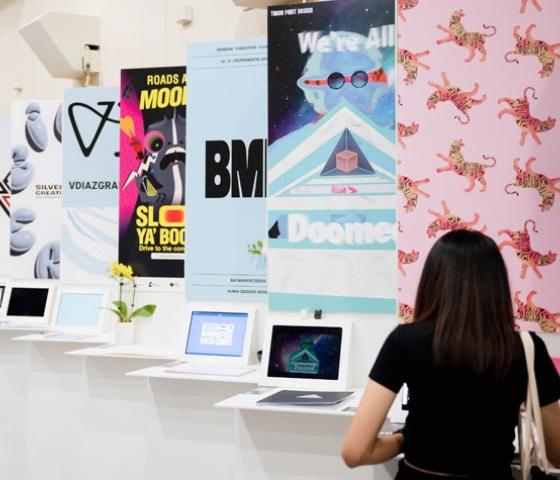 A woman looking at display of graphic design images