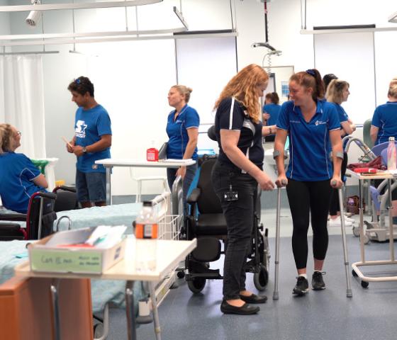 Decorative image - students learning in the sim hospital