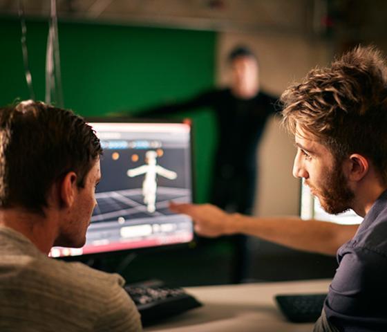 Decorative image - close up of two people working on a digital animation artwork