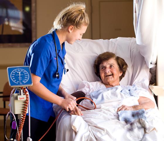 Decorative image - nurse taking blood pressure of elderly patitent
