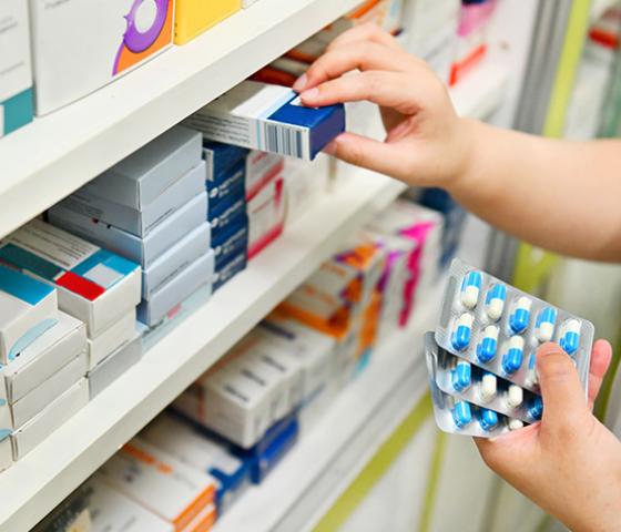 Decorative image - someone accessing medications from shelves